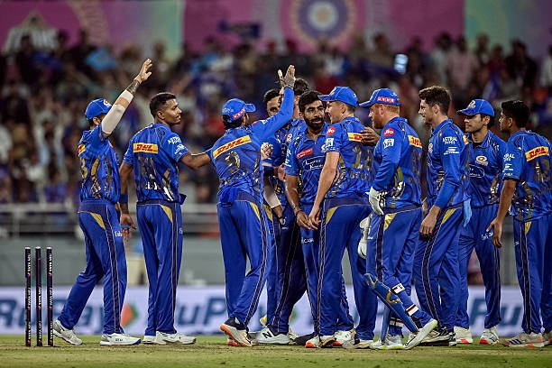 TOPSHOT - Mumbai Indians' players celebrate after the dismissal of Gujarat Titans' Sai Sudharsan during the Indian Premier League (IPL) Twenty20 Eliminator cricket match between Gujarat Titans and Mumbai Indians at the Maharaja Yadavindra Singh International Cricket Stadium on the outskirts of Chandigarh